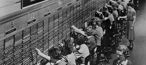 A black and white photo of a row of switchboard operators.